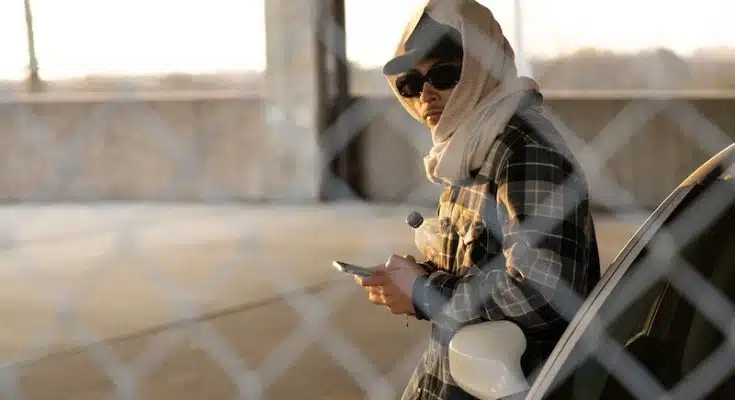 Man Wearing Cap and Headscarf