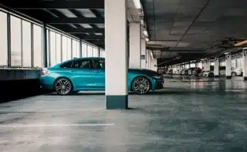 blue car parked on gray concrete floor