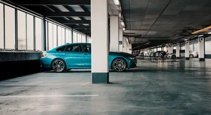 blue car parked on gray concrete floor