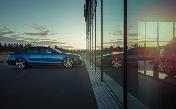 blue sedan on road during daytime