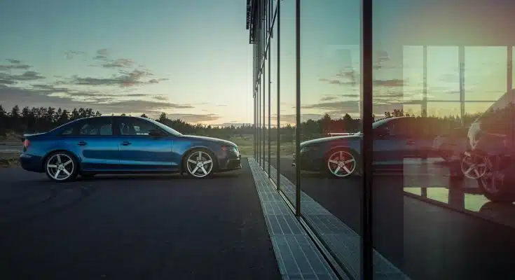 blue sedan on road during daytime